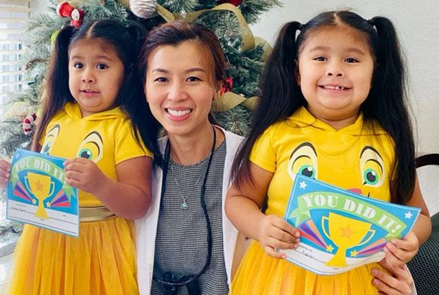 Dentist Dallas TX Nhu Dang with Pediatric Patients Dr. Nhu Dang posing with smiling pediatric patients after they have completed their appointment.