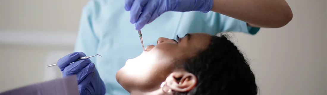 Woman Receiving A Dental Exam